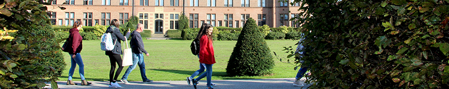 Visitors walking across the rectors lawn