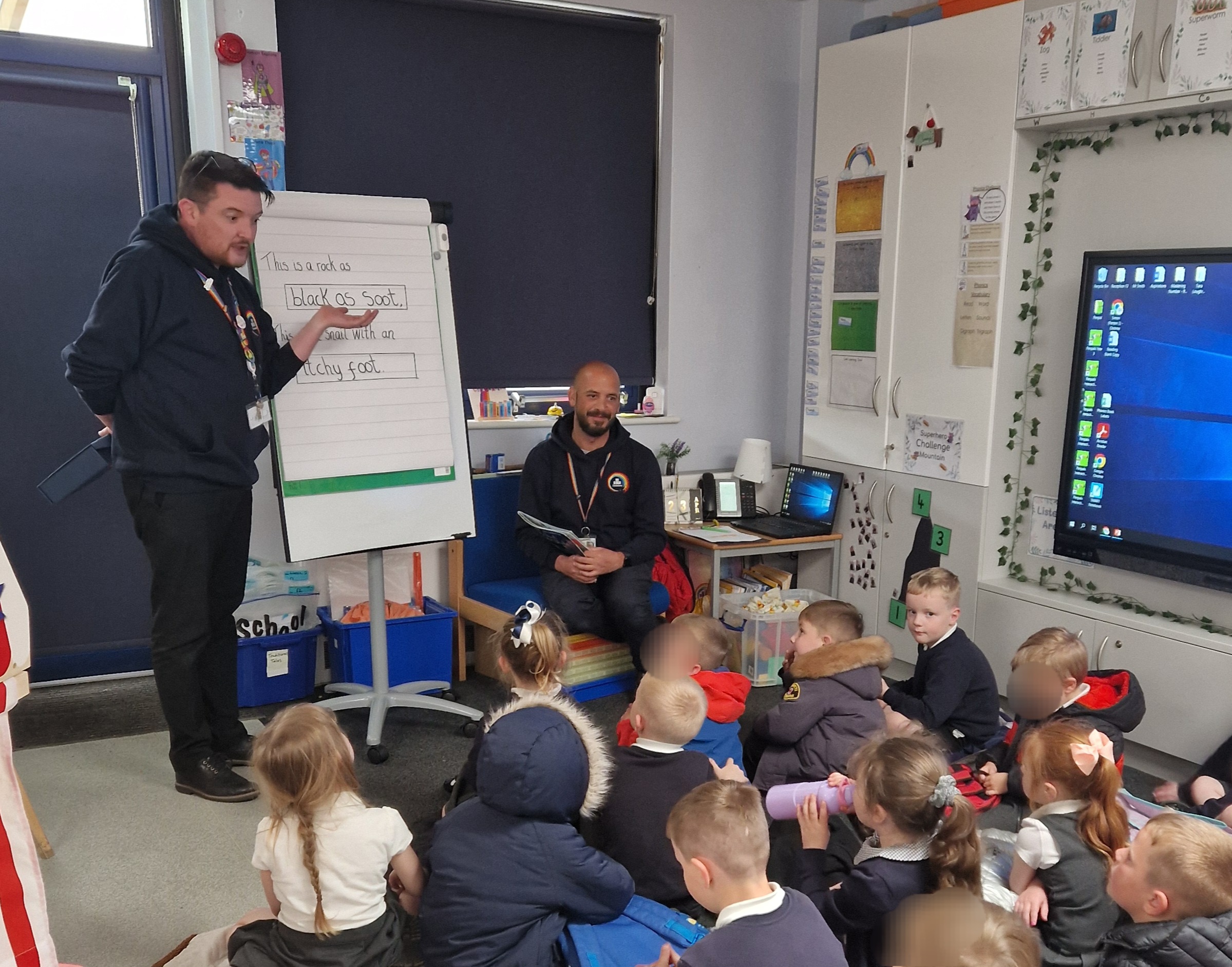 Simon in classroom with pupils.
