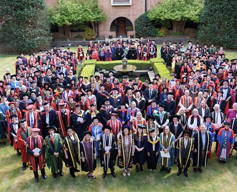 All academics gowned and gathered on the lawn