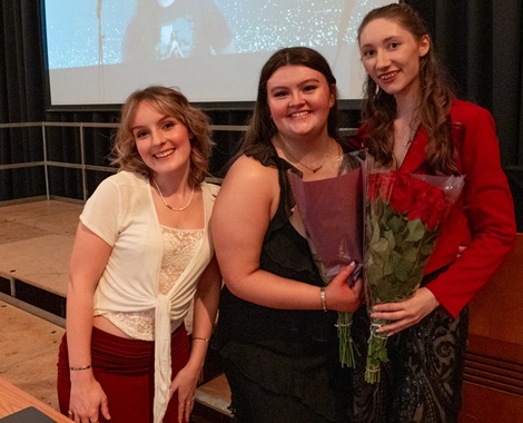 Three SU representatives holding flowers