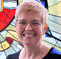 Laura Lightfoot in front of stained glass window