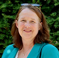 Penny Haughan in front of a garden