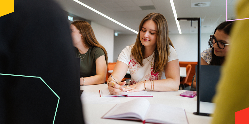 Students studying in a modern learning space, representing learning, academic support and the student experience at Liverpool Hope University.