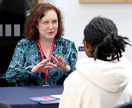 Image of a student speaking to an academic