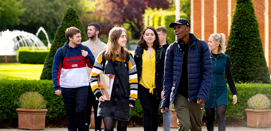 Group of students walking along campus