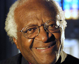 Archbishop Desmond Tutu smiles at the camera