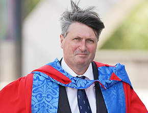 Photo of Simon Armitage with his hair blowing in the wind
