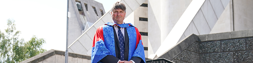 Dramatic head shot of honorary Simon Armitage outside of Cathedral