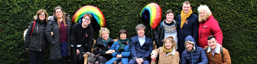 A large group of staff stand together for a photo for a Climate Change rally