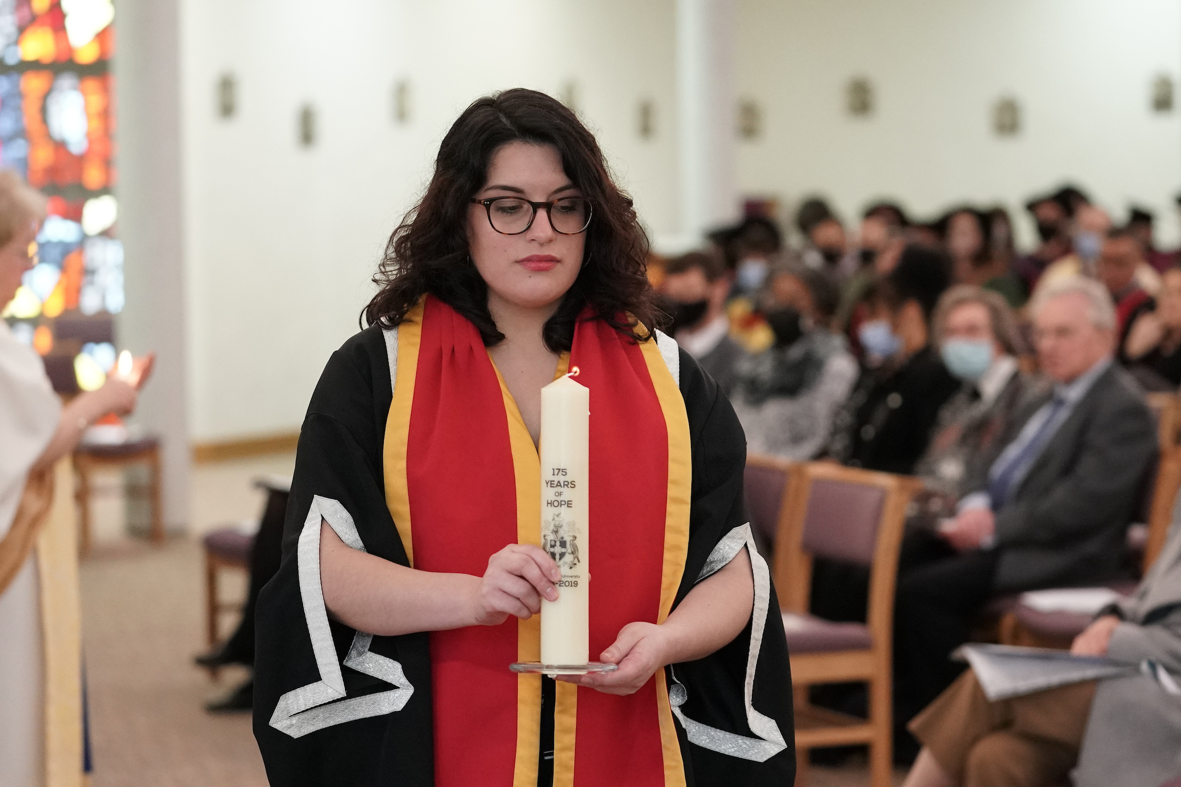 stephanie trujillo carrying candle at service