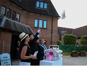 Releasing white dove into the sky as part of the garden celebrations