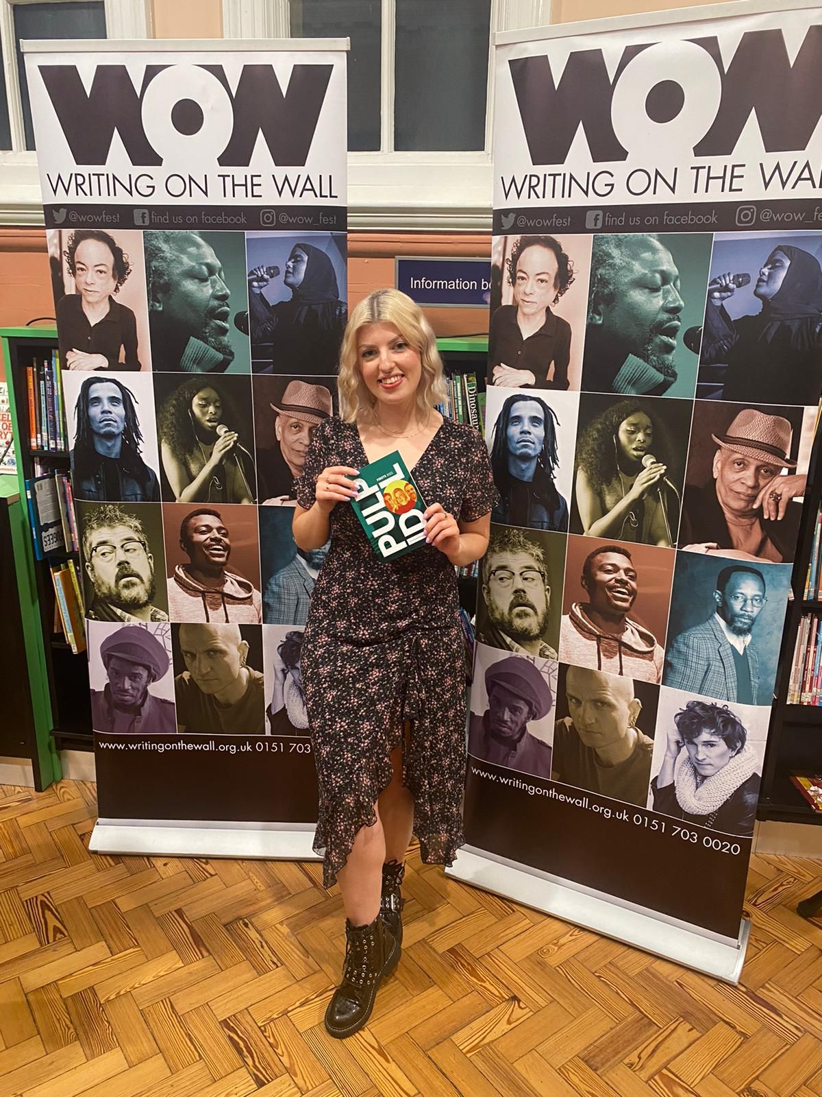 Staff member holding her book up