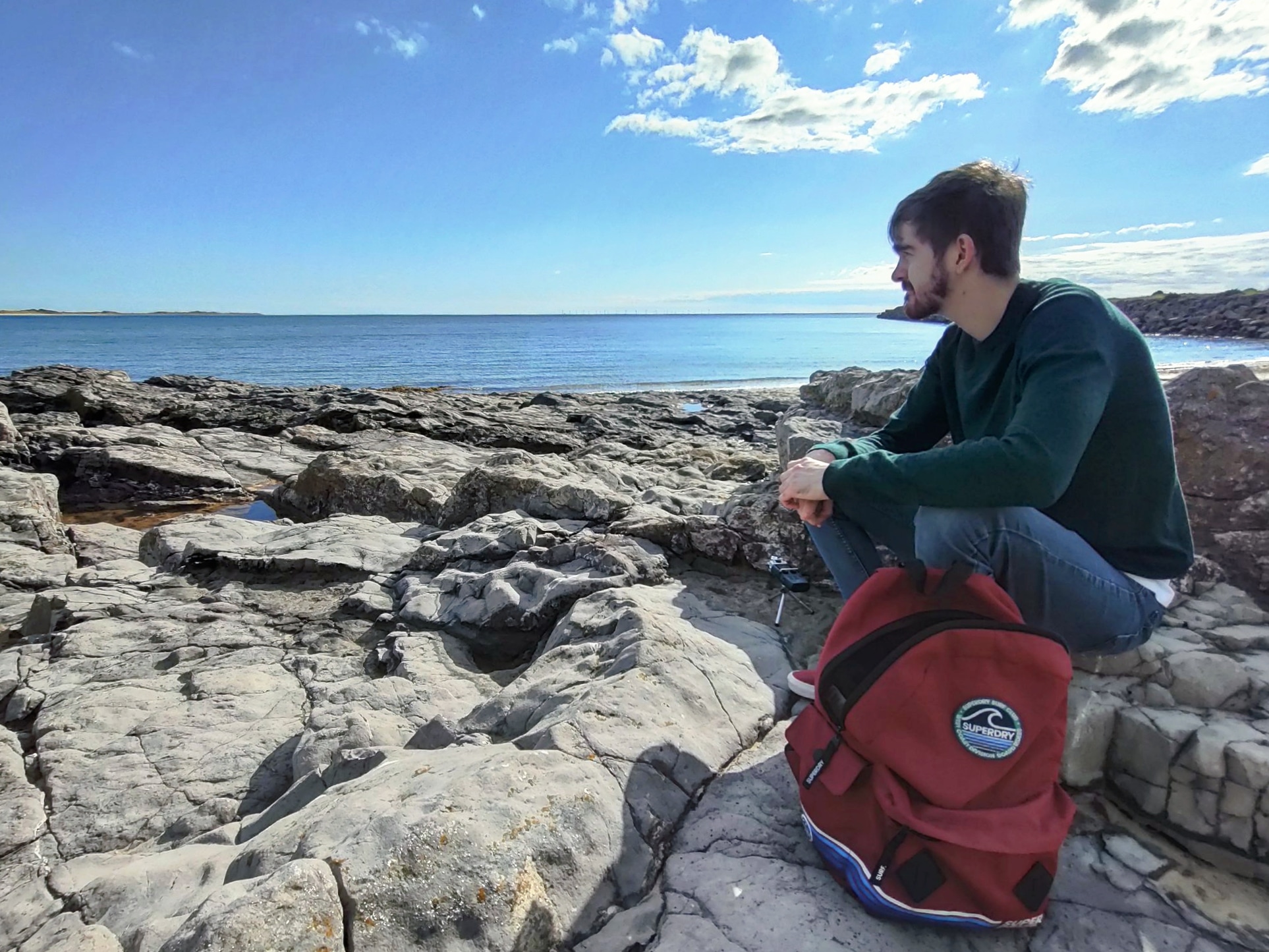 Person sitting on rocks looking into the distance