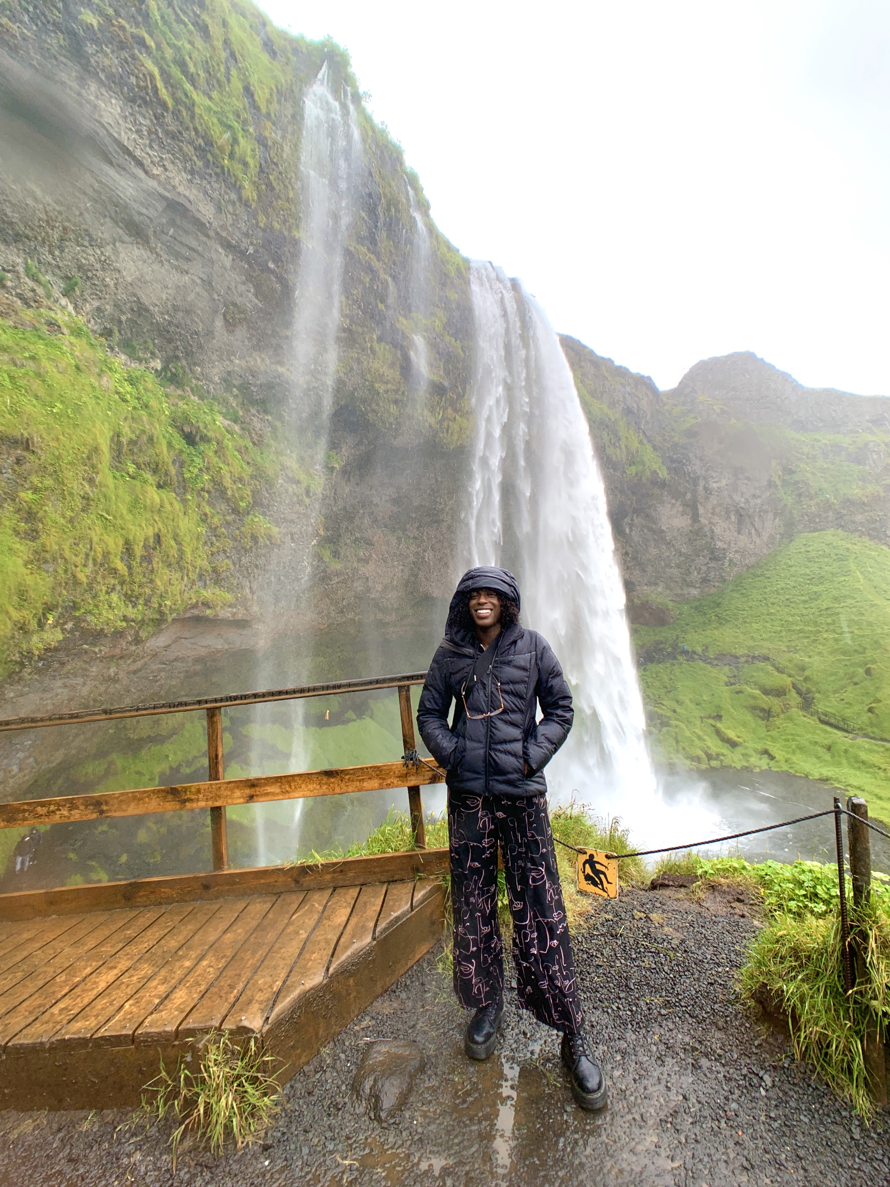 Ife Akinroyeje next to waterfall