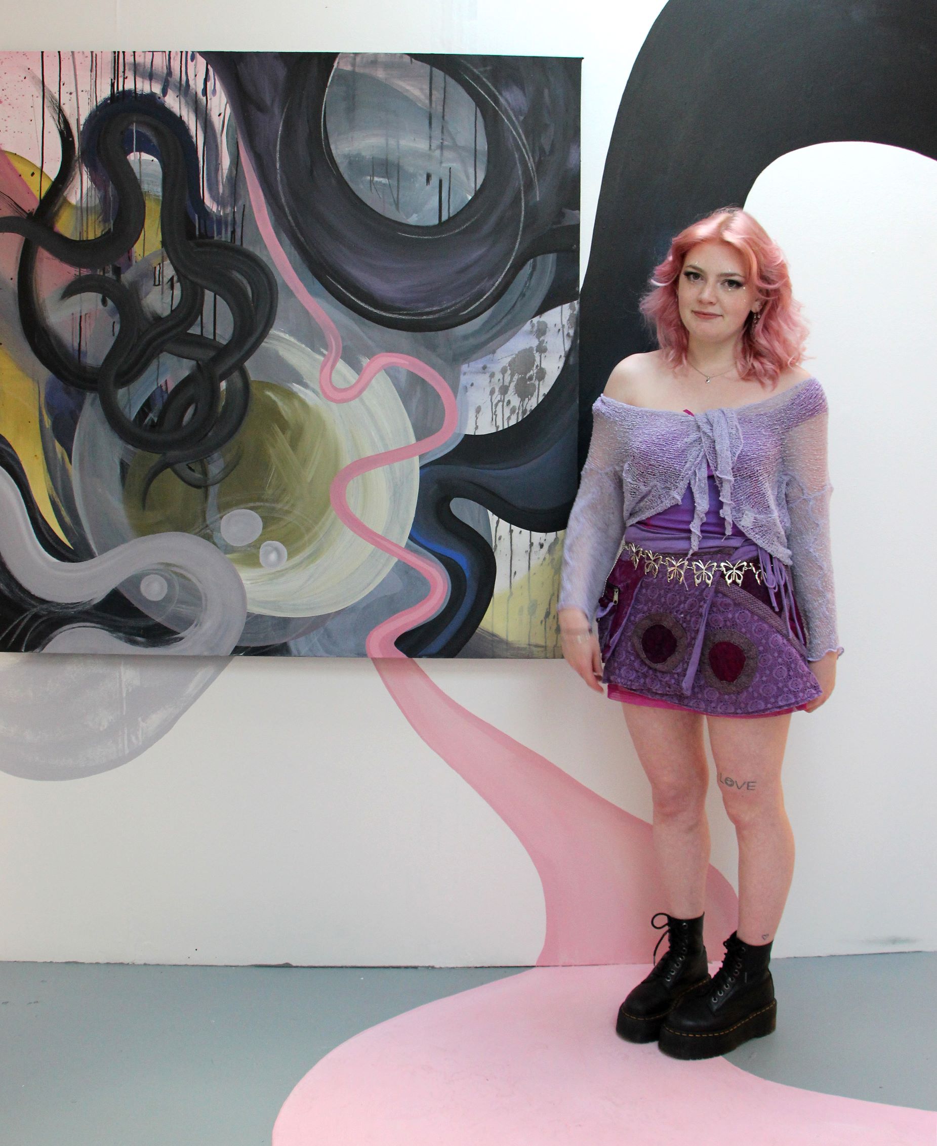 Student poses with artwork
