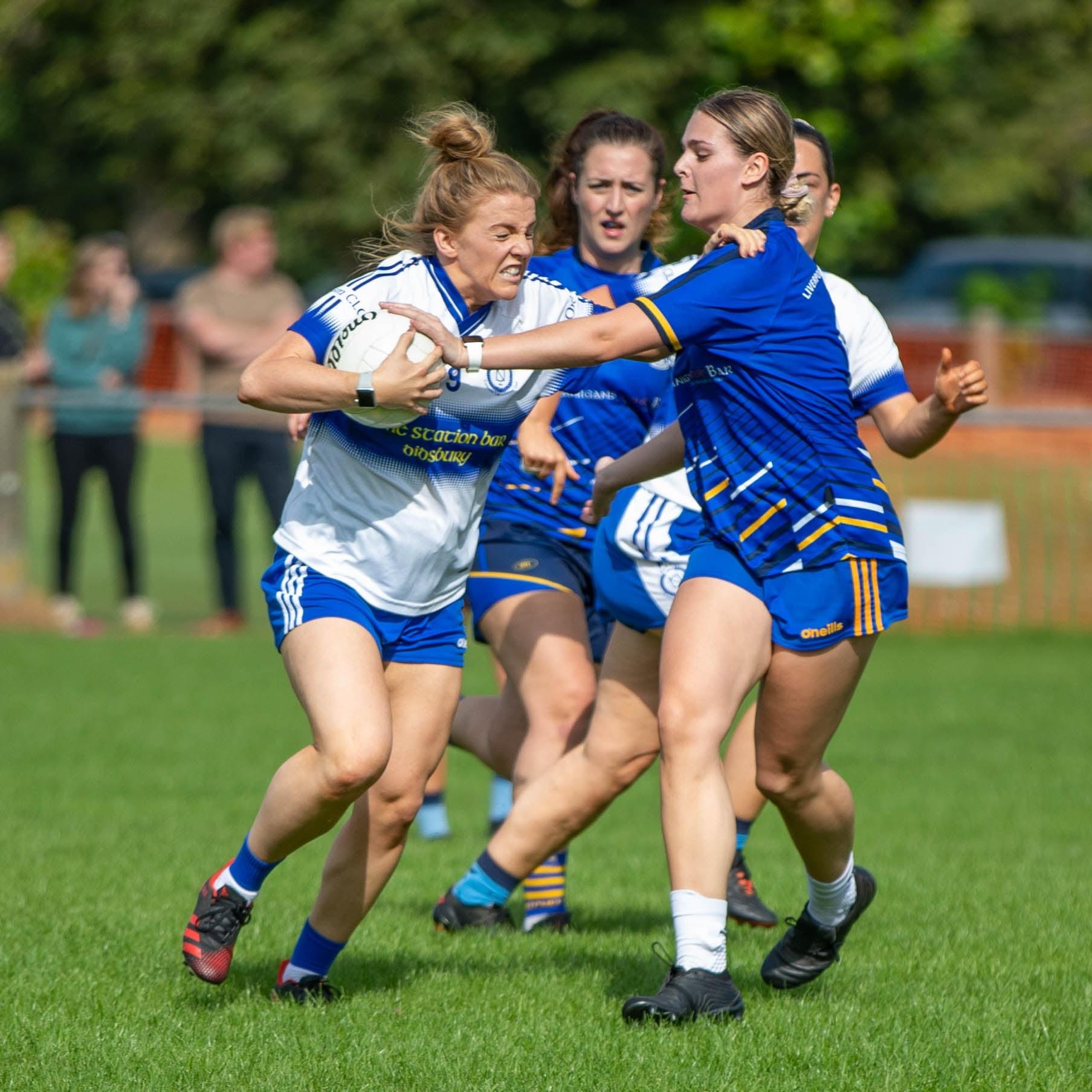 Female Gaelic football player tackling