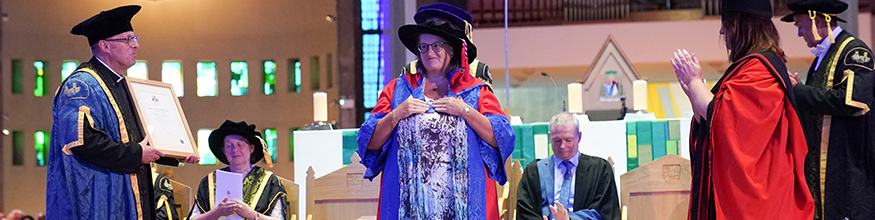 Chancellor receives award on the stage at the cathedral