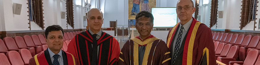 Professors all wearing gowns in the cathedral