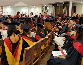 graduates sitting in chapel