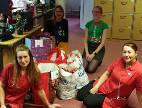 Personnel staff proudly show off the donations they received