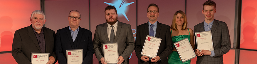 Group photo of the finalists of the Playwriting Prize all holding their scripts