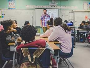 School teacher delivering lesson to pupils