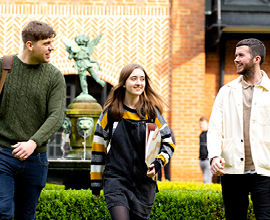 Smiling students and REF logo