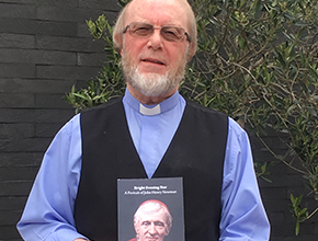 Photo of Rod Garner looking directly at camera holding a copy of his book