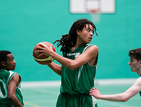 Student basketball player holding ball in hands