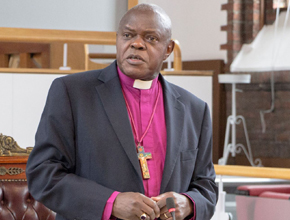 Bishop John Sentamu talking to people in the Senate room