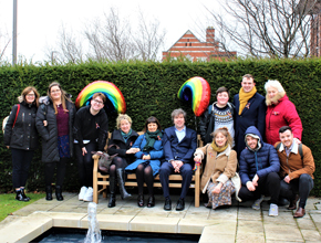 Students sitting on the memorial bench at the Creative Campus