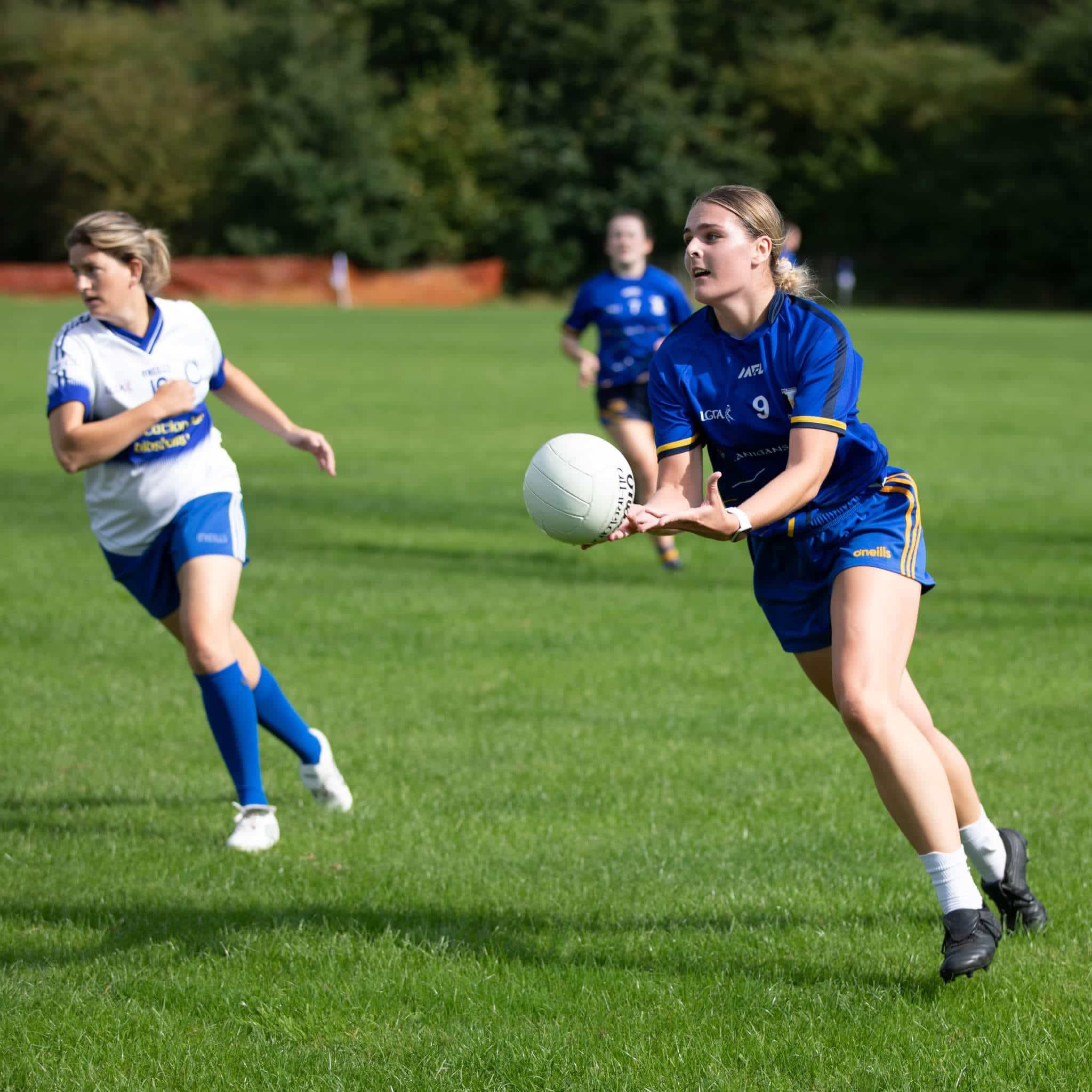 Female Gaelic football player in action