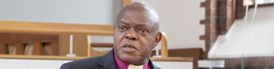 Bishop John Sentamu talking to people in the Senate Room