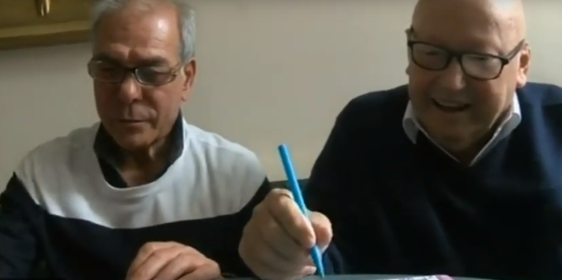 Two older gentlemen playing bingo together