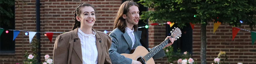 Celebrations for garden party with man playing guitar and singing