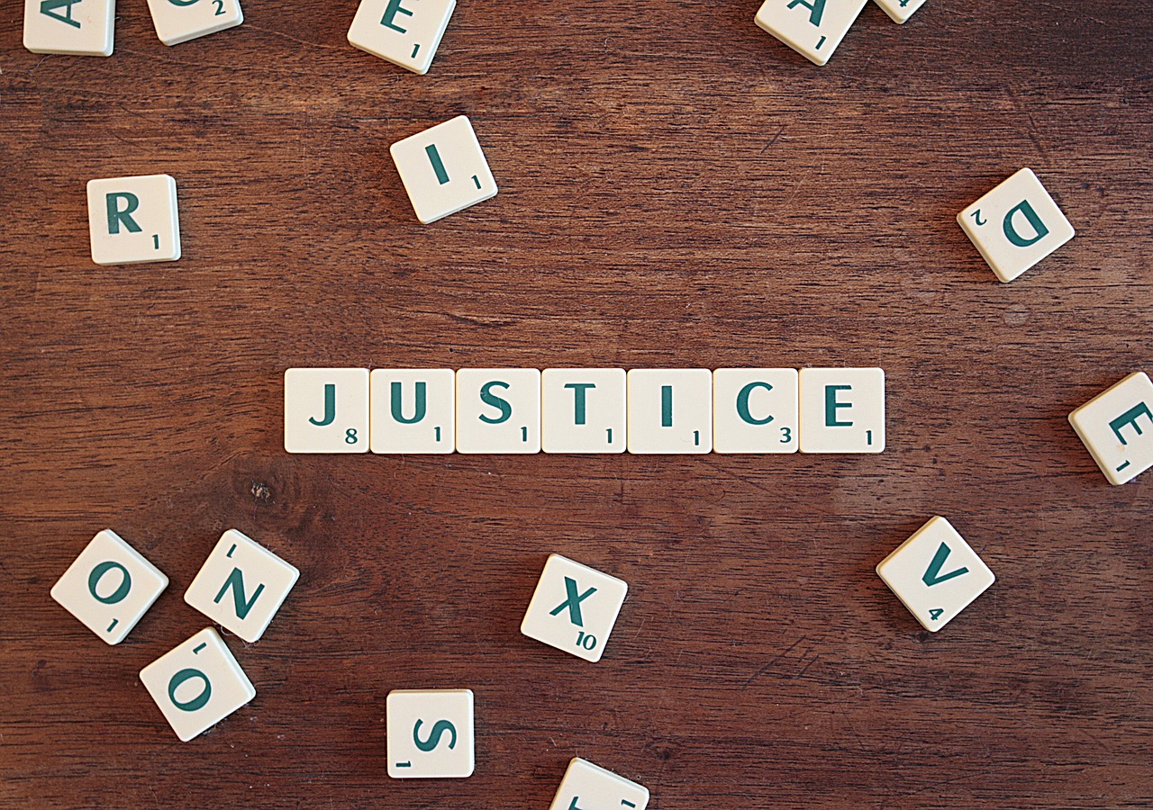 scrabble letters spelling the word justice