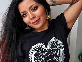 Student posing with arm on head wearing a black t-shirt