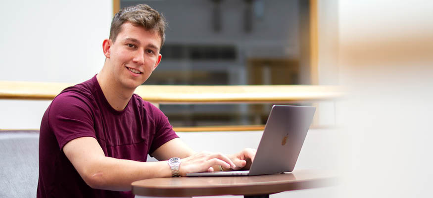 Liverpool Hope student studying on a laptop
