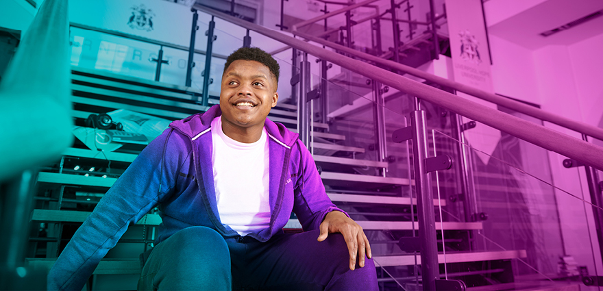 Student sat on steps in front of Cornerstone Theatre, Creative Campus