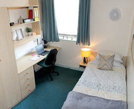 Students room in accommodation, single bed, desk and bookcase are visable