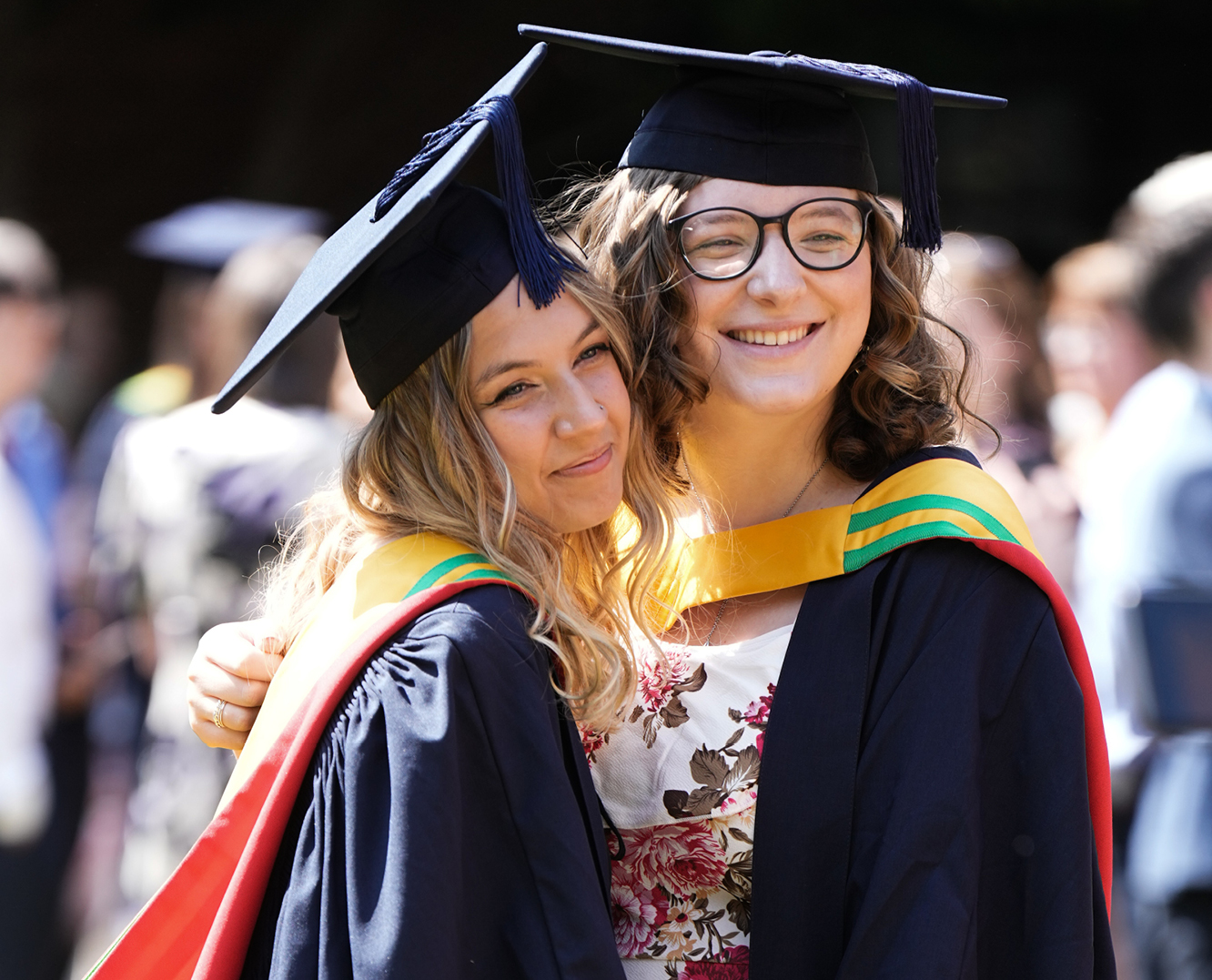 Two students celebrating their graduation